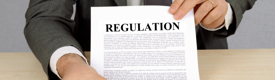 man holding paper that says regulation