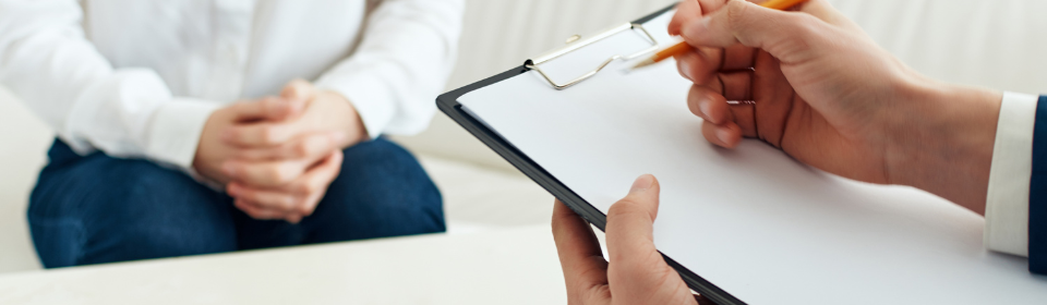 person writing on checklist