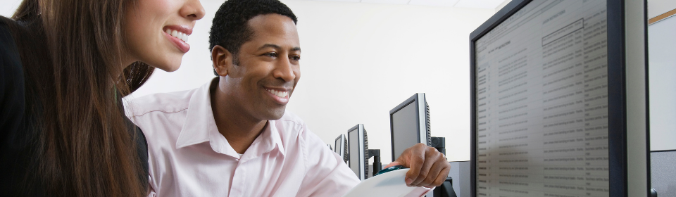 two people working together on computer